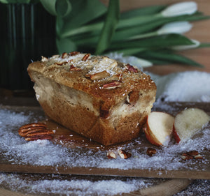 Pecan Cake on a wooden board with apples and coconut shreds