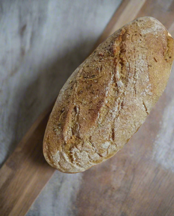 Loaf of artisan bread on a wooden surface